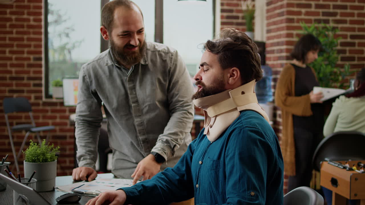 Business man in pain wearing cervical neck foam at office job