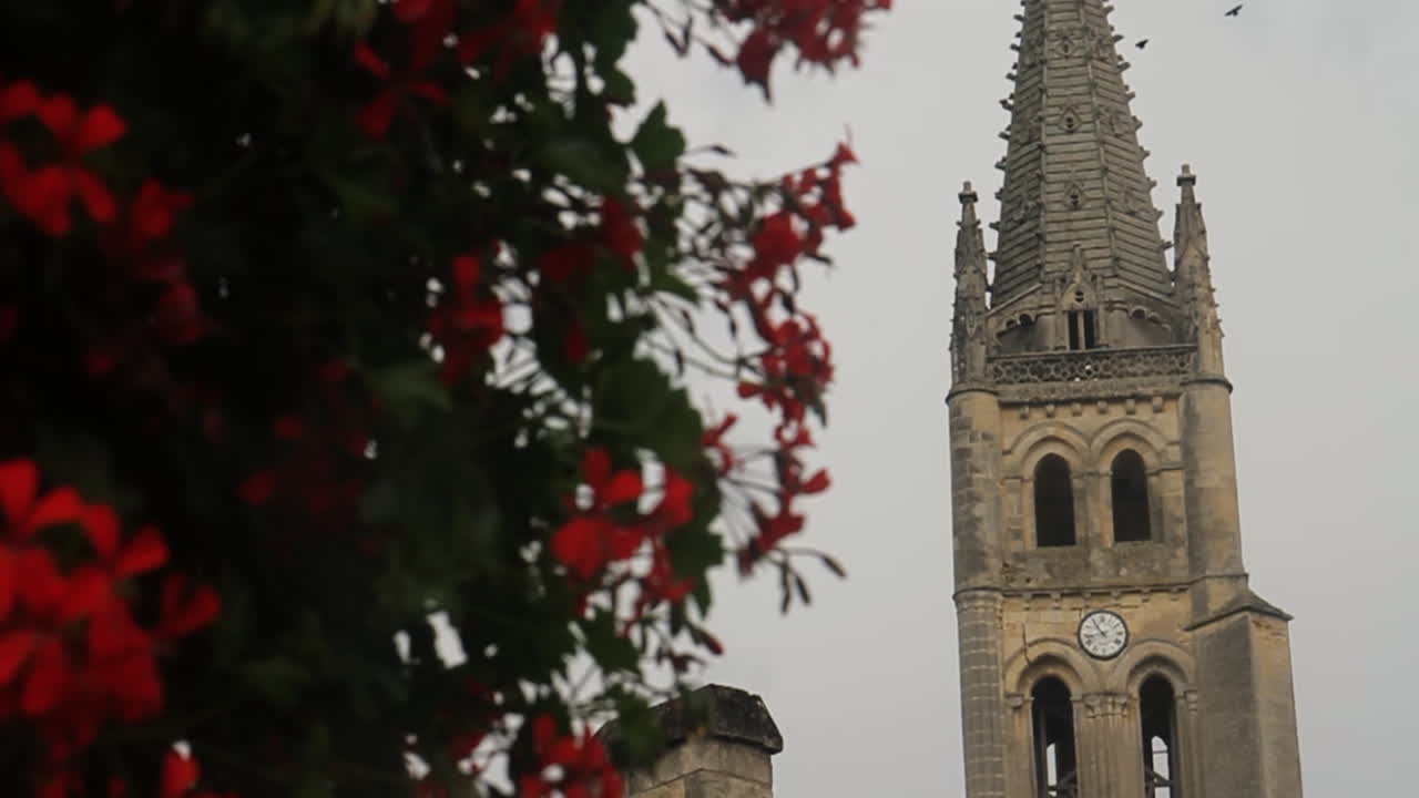 Church steeple with red flowers
