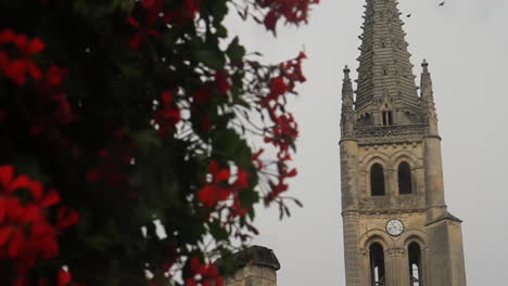 church steeple with red flowers