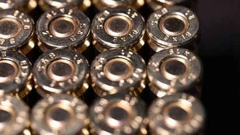 very slow close-up of 9mm bullets for pistol, personal protection weapon, or rifle