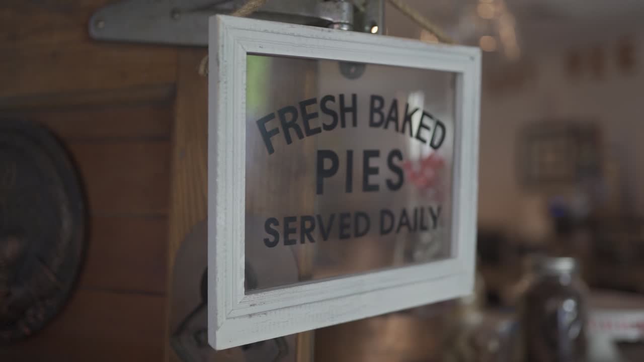 Fresh baked pies sign coming into focus in slow motion.