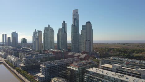 aerial establishing shot of some puerto madero's skypcrapers with blue sky as background