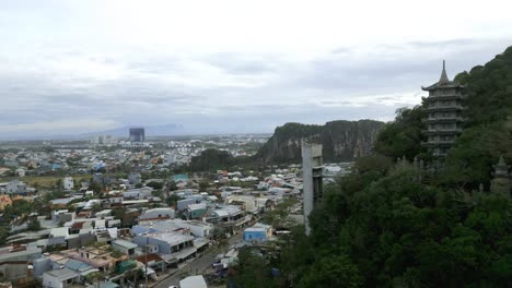 Magical-aerial-shot-of-Da-Nang,-Marble-Mountains-in-Vietnam-on-a-cloudy-day