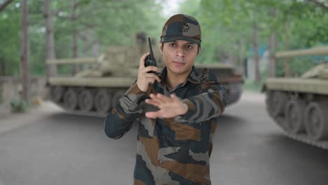 indian army man giving instructions on walkie talkie