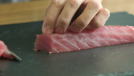 close up of fish meat being sliced