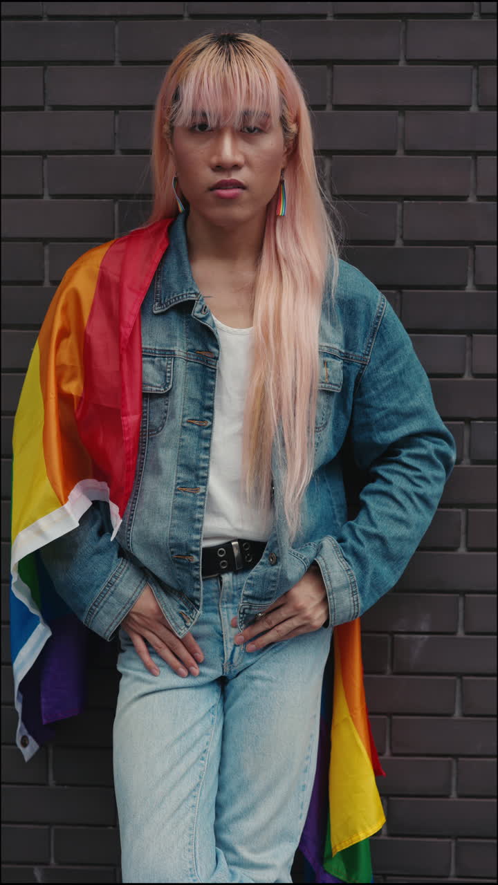 Portrait of a person draped in a pride flag