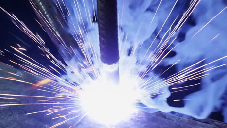 dynamic close-up of industrial welding process with sparks and molten metal
