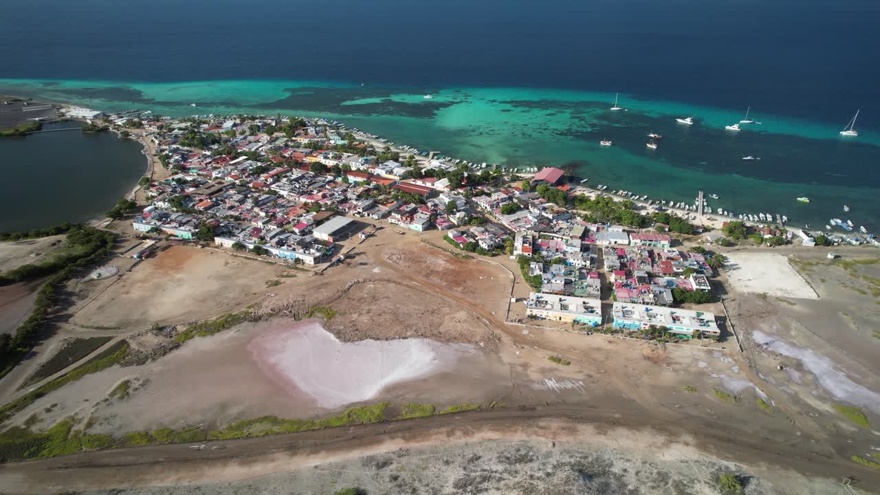 Aerial view moving backward over Gran Roque town and lighthouse at Los Roques in the Caribbean
