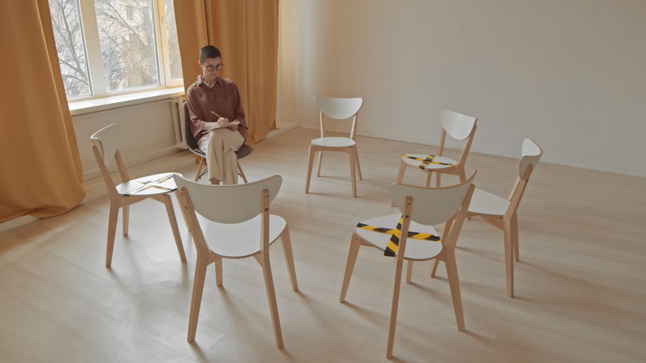 Empty chairs maintaining social distance at an indoor meeting