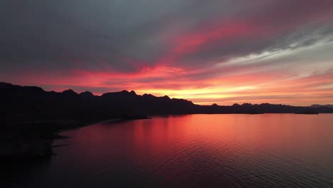 fiery sunset with reflections over the beach at baja california sur in mexico