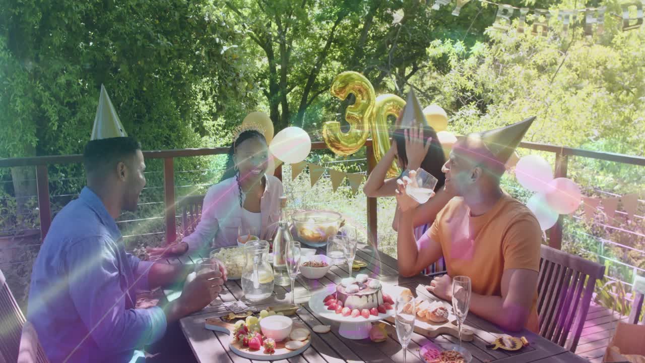 Four friends raising glasses, clinking, celebrating 30 on deck with cake, balloons event planning