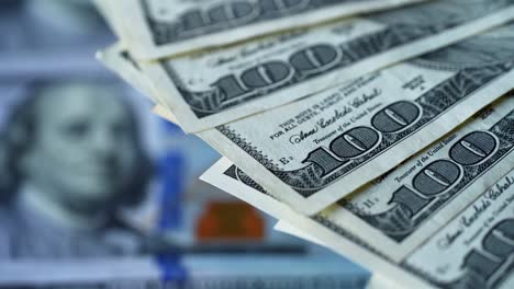 cash american money. hundred dollar bills moving in a circle way. rotation of paper money of one hundred dollar banknotes. macro shot.