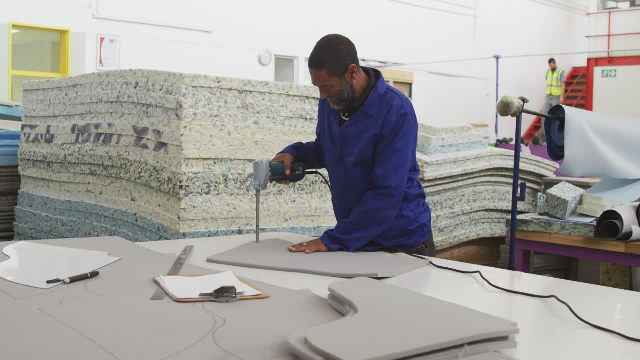 Worker cutting the pattern on a cardboard