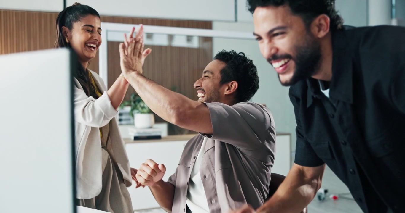 Diverse Team Celebrating Success in Modern Office