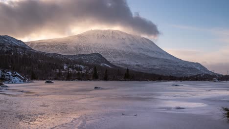 time lapse footage of a mountain top covered in the clouds at sunset