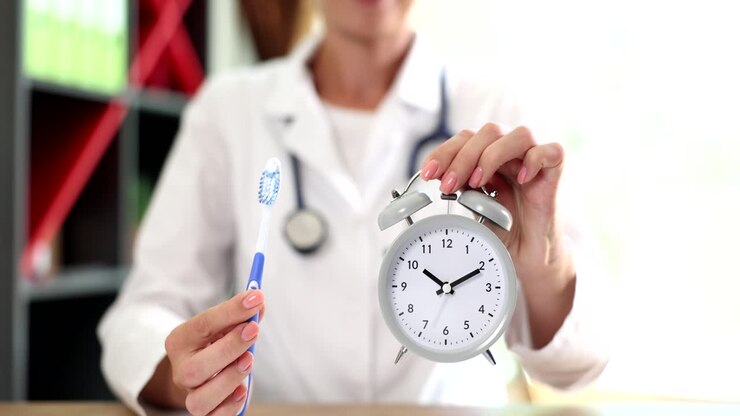 Doctor Demonstrates Proper Brushing Time with Alarm Clock