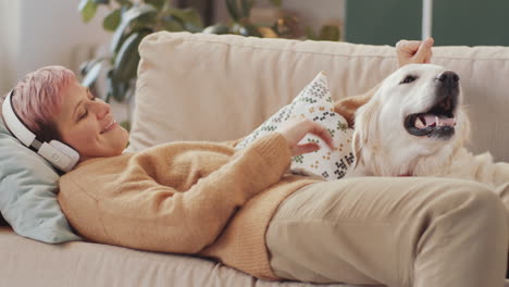 woman relaxing on couch with her dog