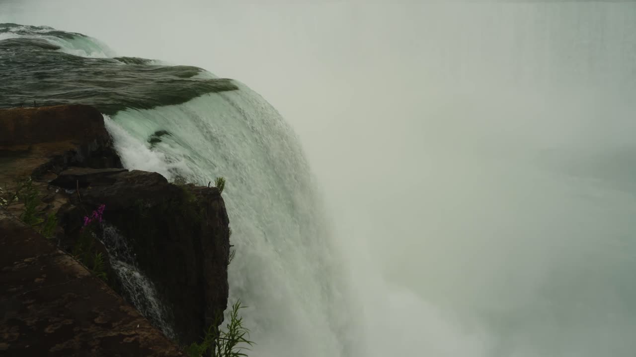 Close-up shot of the powerful drop at Horseshoe Falls, capturing the intensity of water crashing over the cliff’s edge into misty oblivion