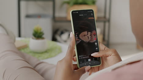 woman using smartphone to watch social media videos