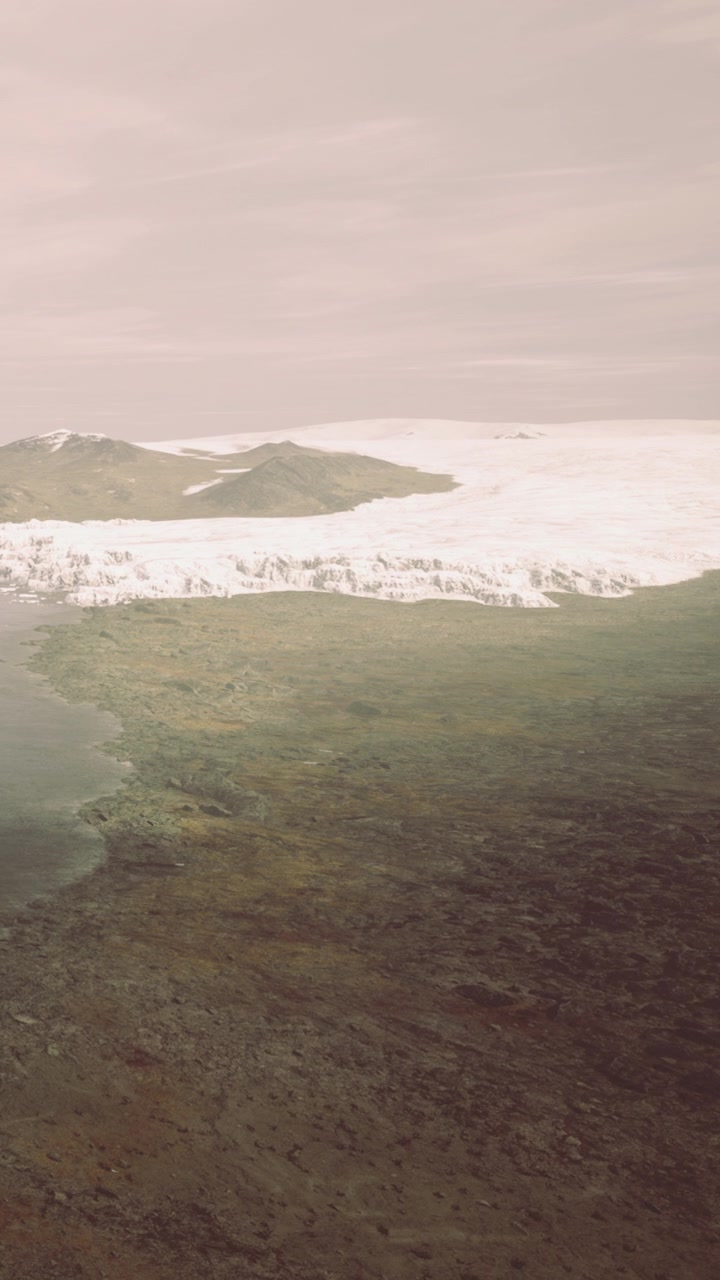 View of glacier meeting land at twilight near a mountain range in iceland