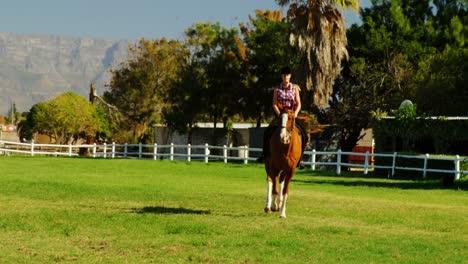 Woman-riding-horse-in-ranch-4k