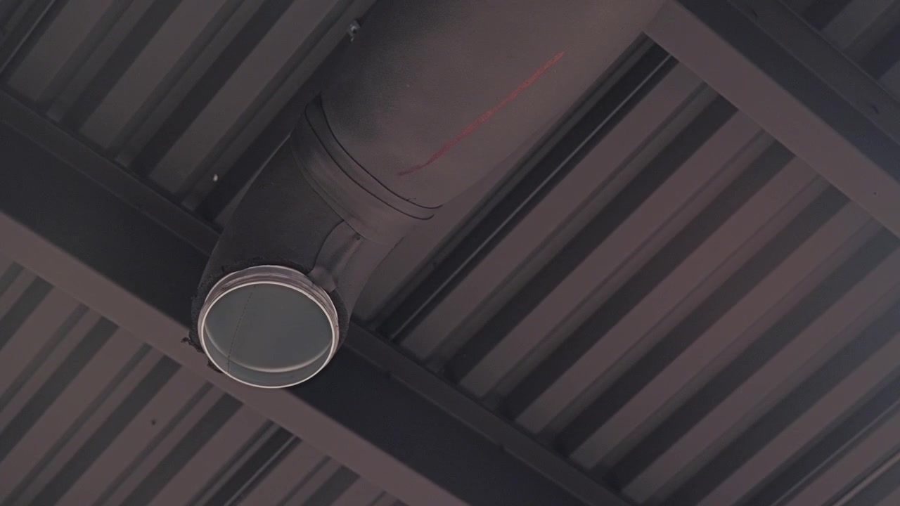 Installed HVAC air duct with foam insulation inside modern commercial facility