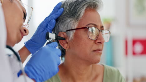 doctor, elderly patient and ear exam