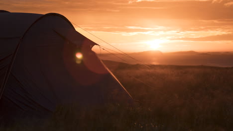 Camping-in-Lofoten-in-a-tent-at-sunset-zoom-out-timelapse