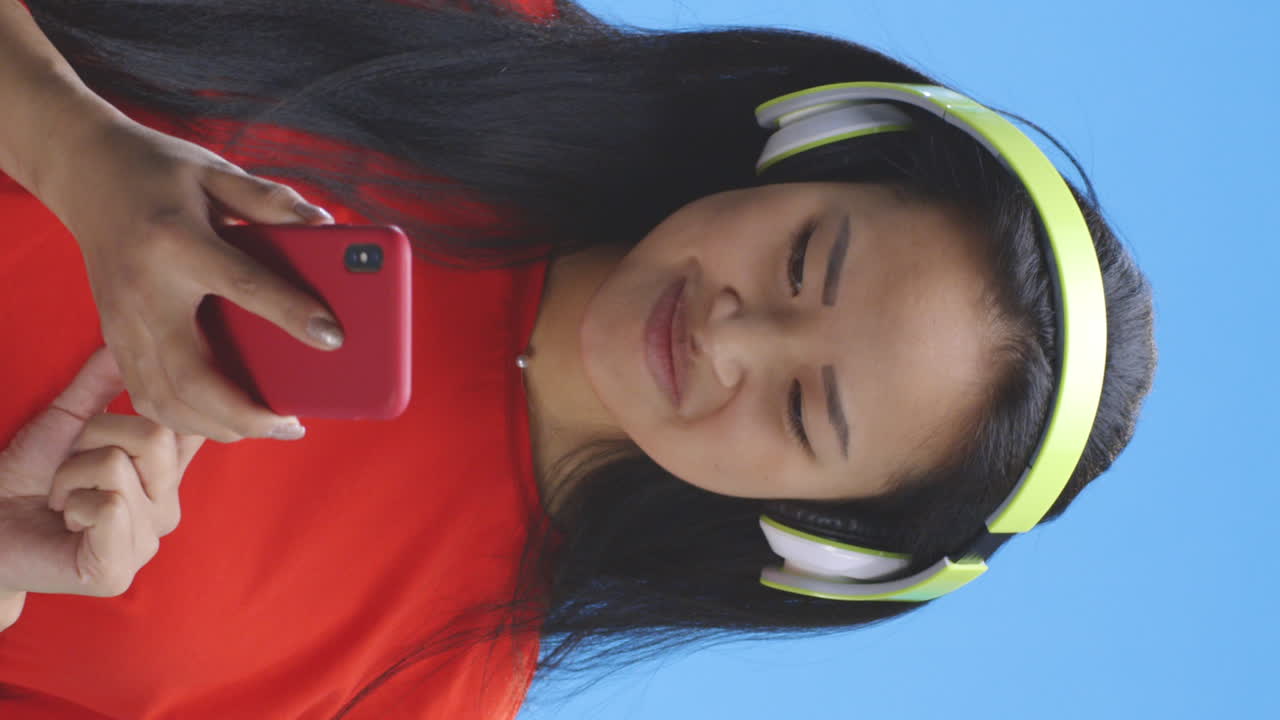 Woman using phone with headphones