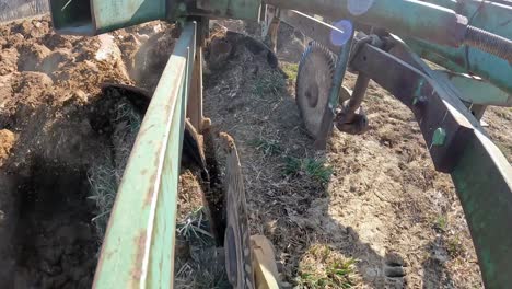 close up of plow as the soil is cut and turned