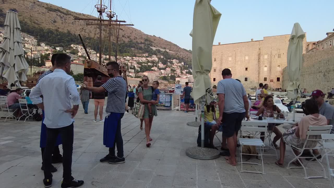 A bustling square in Dubrovnik, Croatia, filled with locals and tourists. Historic charm meets lively atmosphere in this vibrant, picturesque destination.