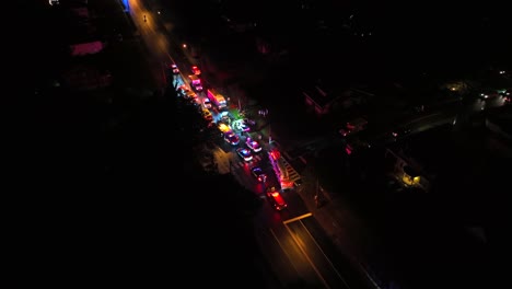 emergency response at night: aerial view of firetrucks, police, and ambulances at accident scene