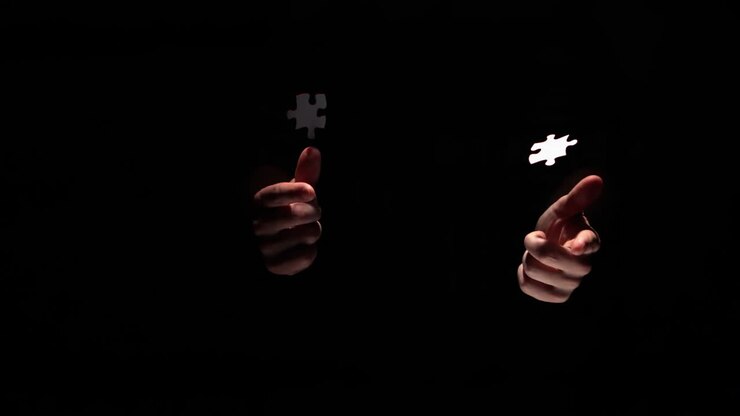 Hands taking apart jigsaw pieces
