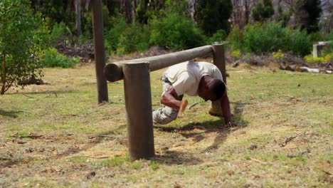 Military-solider-running-over-hurdles-during-obstacle-course-4k