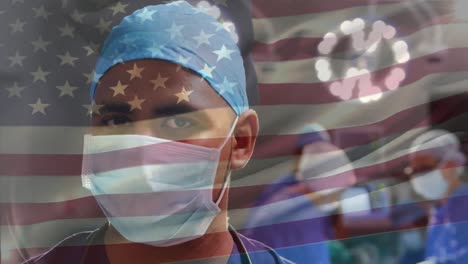 animation of waving usa flag over portrait of biracial male surgeon in surgical mask at hospital