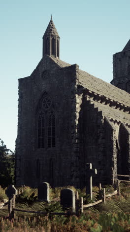 a gothic church with a graveyard in front of it