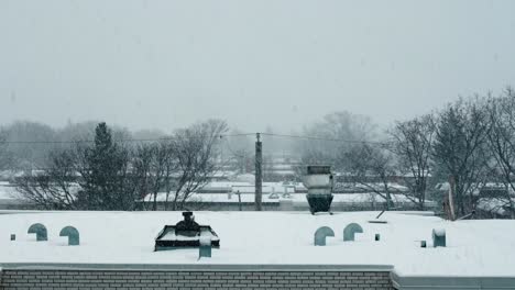 electric cable behing urban snowy rooftop with chimneys 4k