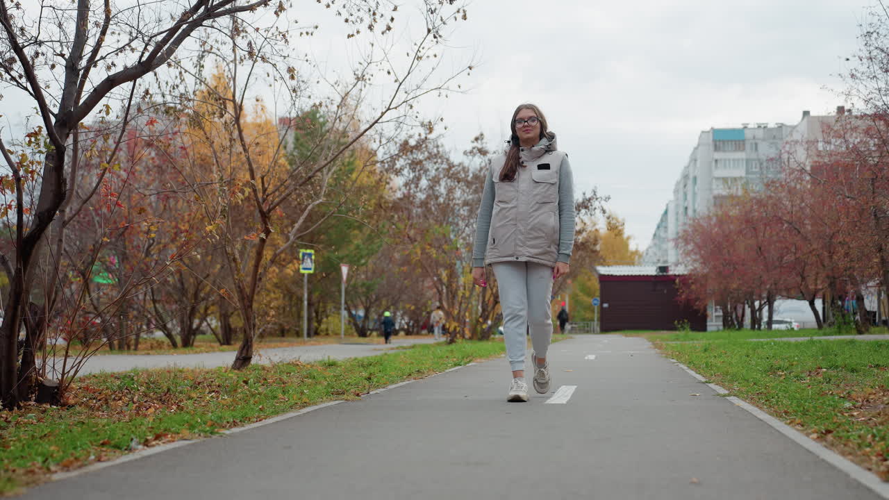 Designer going for walk in beautiful outdoor park with people moving in ...