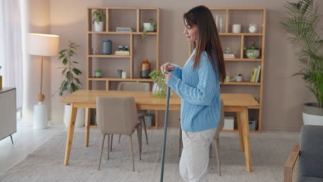 woman mopping the floor in her living room