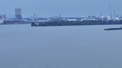 Nuclear-Plant-and-Windmills-by-a-River-in-Moerdijk,-Netherlands