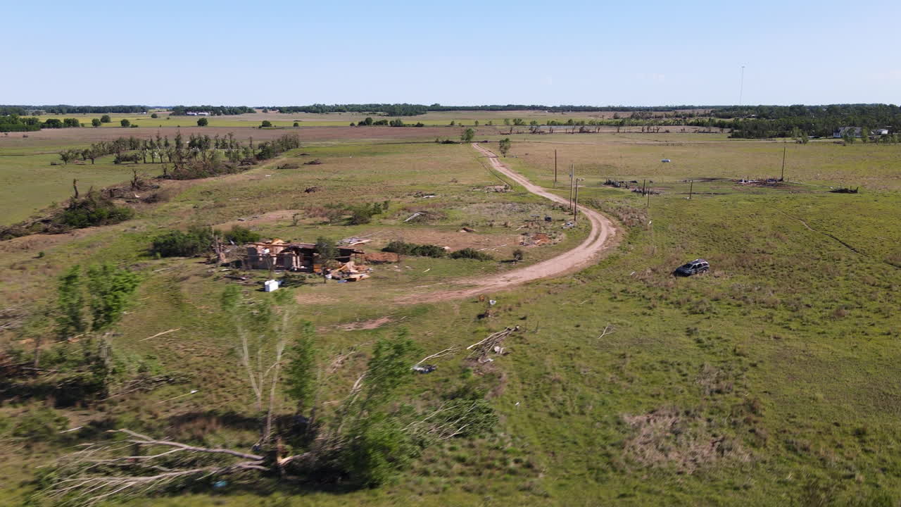 Aerial view approaching a destoyed house, Twister aftermath in sunny Kansas, USA