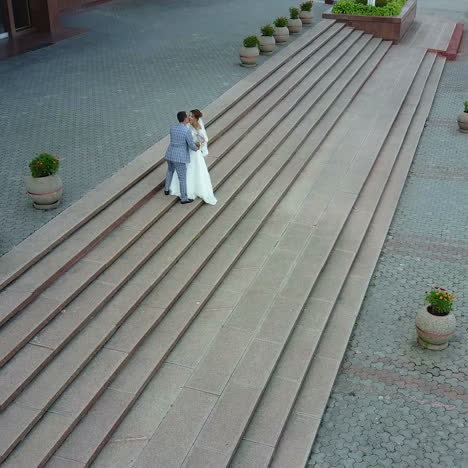 aerial view. just married couple walking in the city. beautiful bridal couple square video