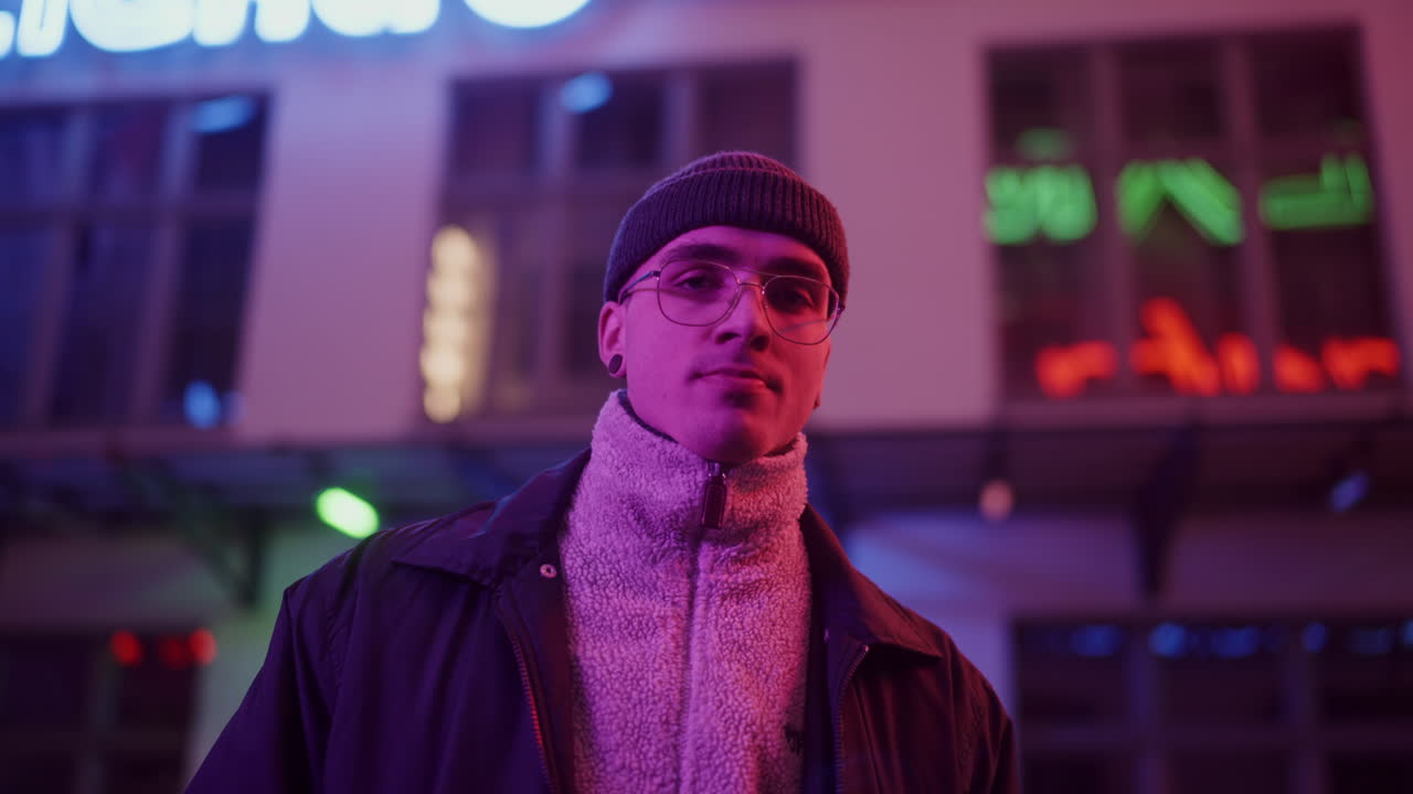 Young Man in Neon City Lights