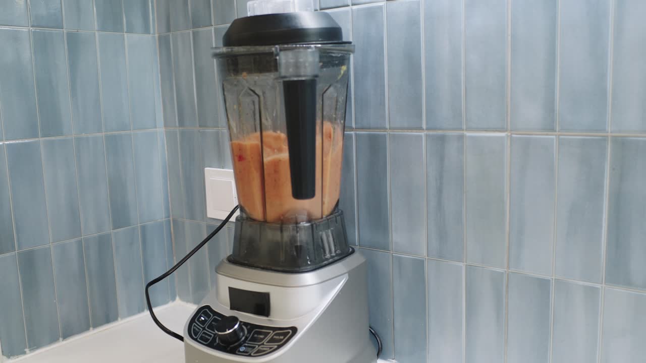 Blender with smoothie in a kitchen setting