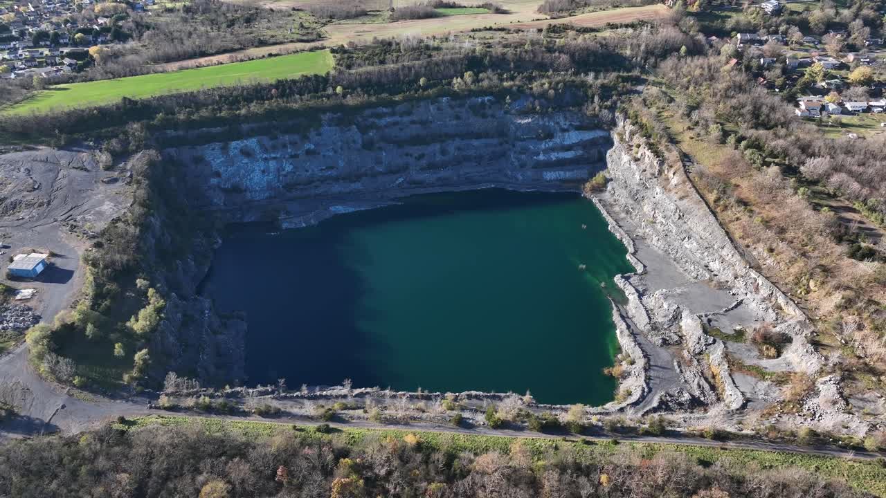 Aerial top down shot of natural lake of Frazier Quarry in Harrisonburg, Virginia. Suburb district in USA. New developed housing area project.