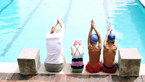 Rear-view-of-female-trainer-training-her-young-students