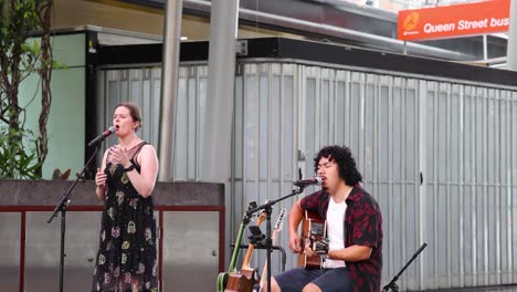 two musicians performing together outdoors