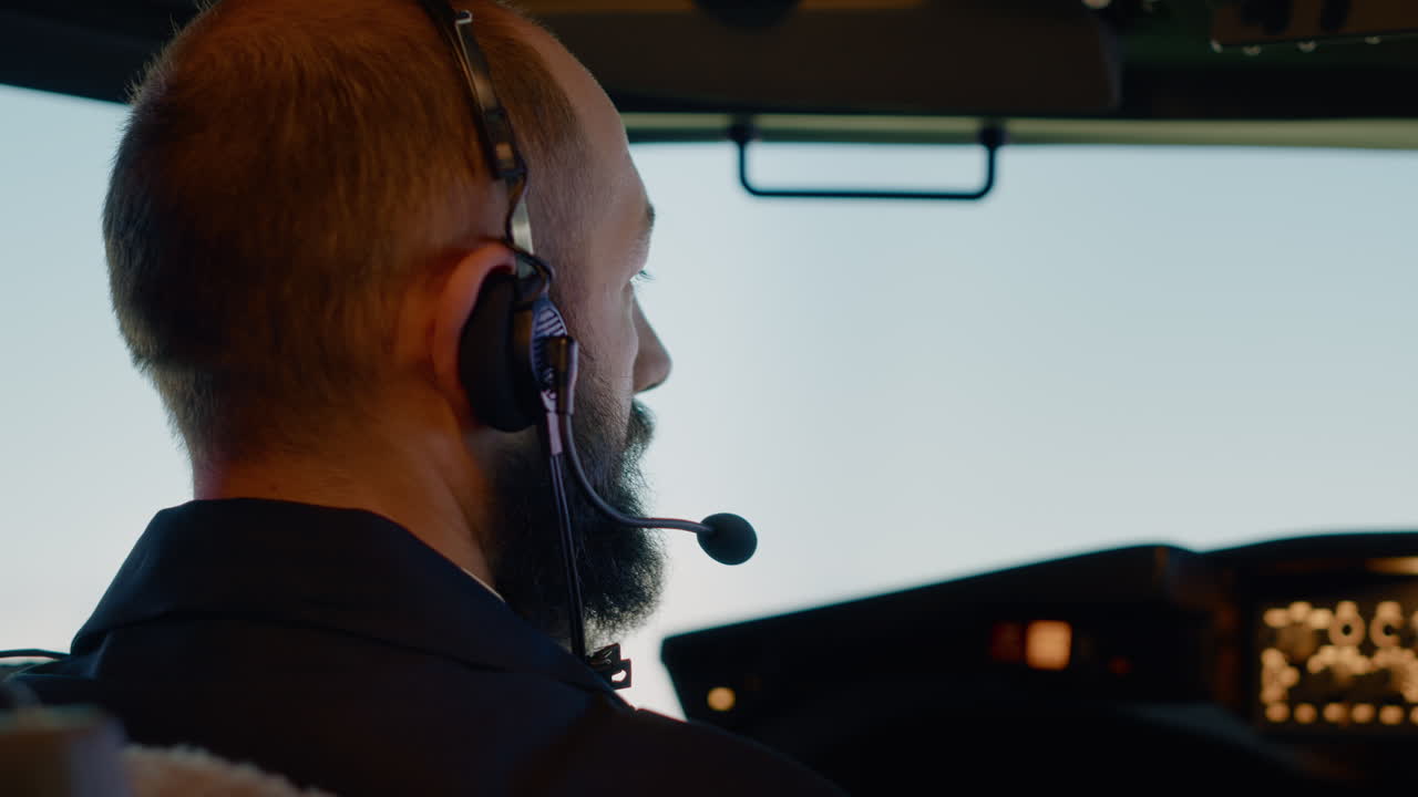 Male captain pilot flying airplane with dashboard command
