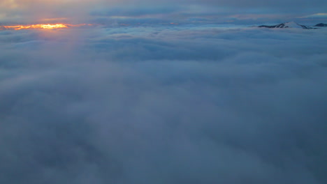 Aerial-Hyperlapse,-Timelapse-of-midnight-sun-above-clouds-in-Northern-Scandinavia,-forwarding-drone-shot