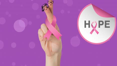 Animation-of-breast-cancer-awareness-text-over-hand-and-pink-breast-cancer-ribbon